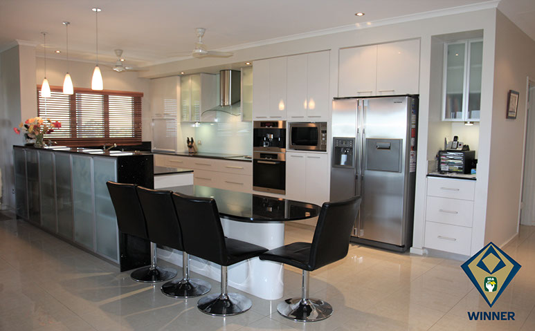 Kitchen with 2-pack painted finish, granite benchtops, aluminium framed frosted glass doors and glass splashback.