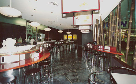 Curved solid timber high tables in Jarrah with stainless steel surround.