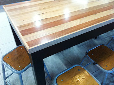 Solid timber tables, benches, columns and wall cladding.