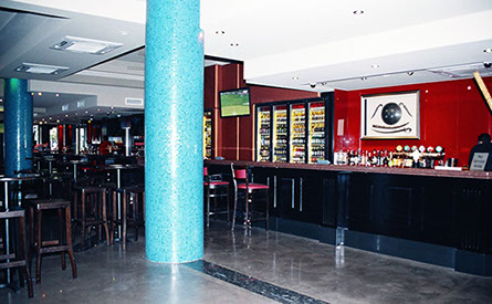 Routed painted panels with granite tops on bar and DJ booth and open shelving for bottle storage.